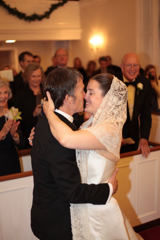 Bride touches groom's face during an outdoor wedding ceremony