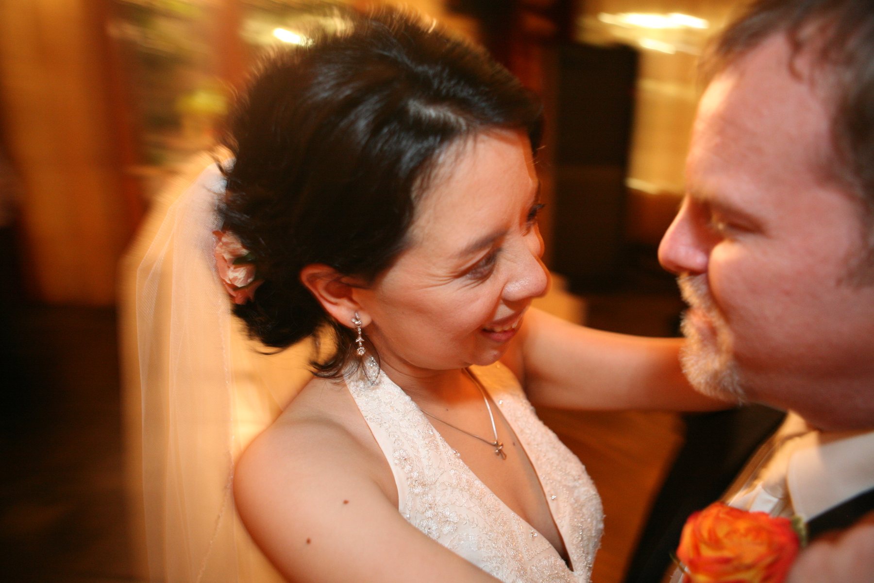Bride and groom in a warm candid reception moment