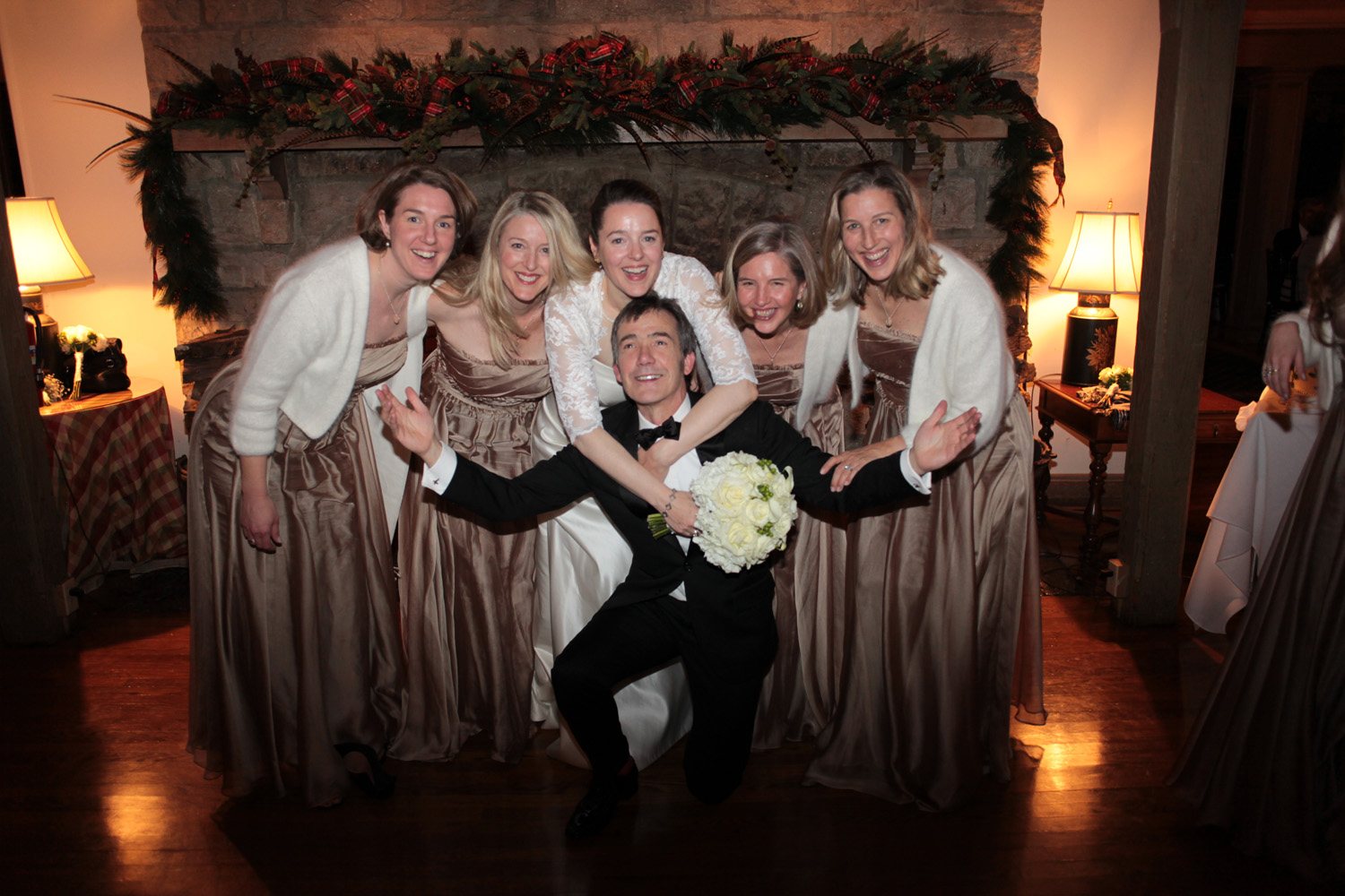 Bride and groom surrounded by family during wedding reception