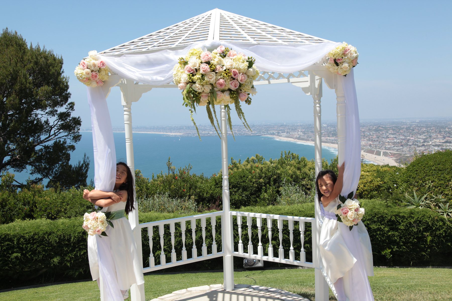 Wedding gazebo with flower girls and Los Angeles coastline
