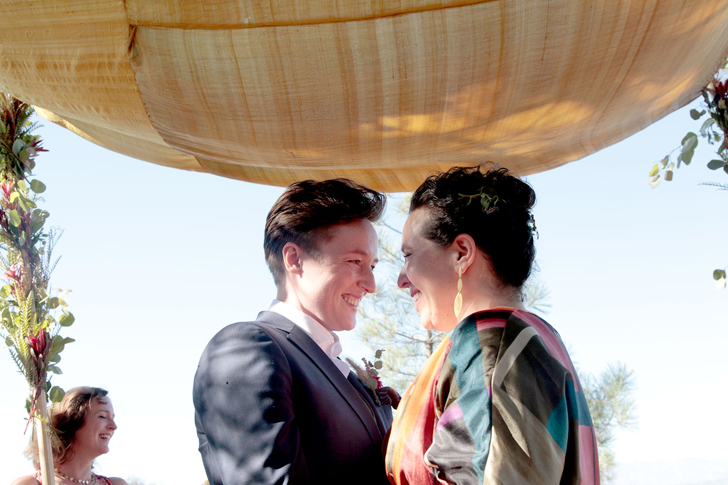 Same-sex wedding ceremony moment under a fabric canopy in Los Angeles