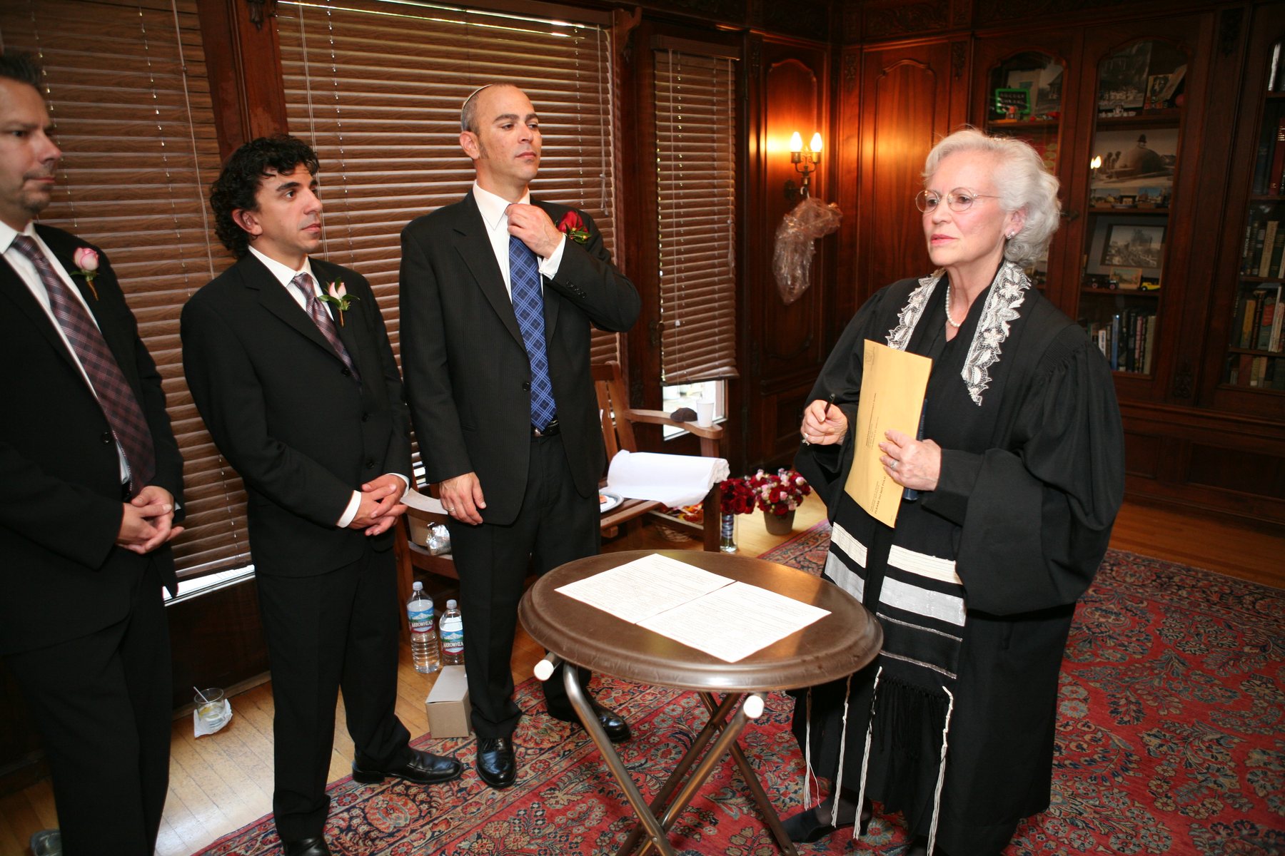 Rabbi and groomsmen during Jewish wedding ceremony
