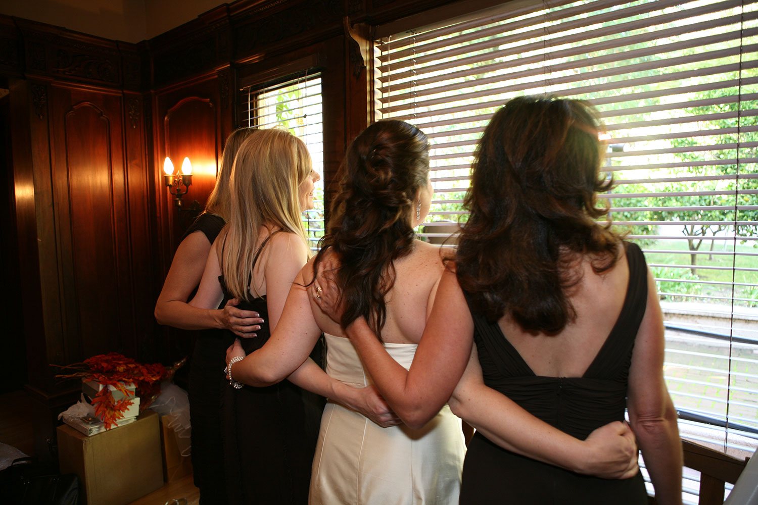 Bridesmaids supporting bride before wedding ceremony
