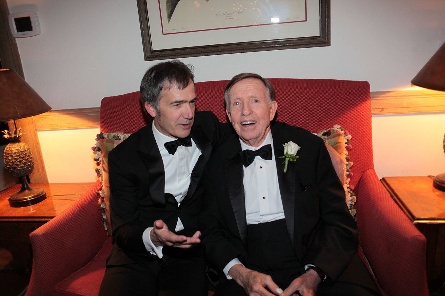 Wedding guests candid moment on red sofa