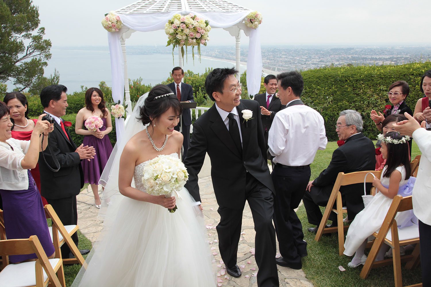 Bride and groom walking down aisle after outdoor ceremony